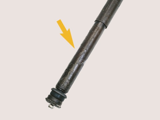 Underbody sealant on shock absorber 